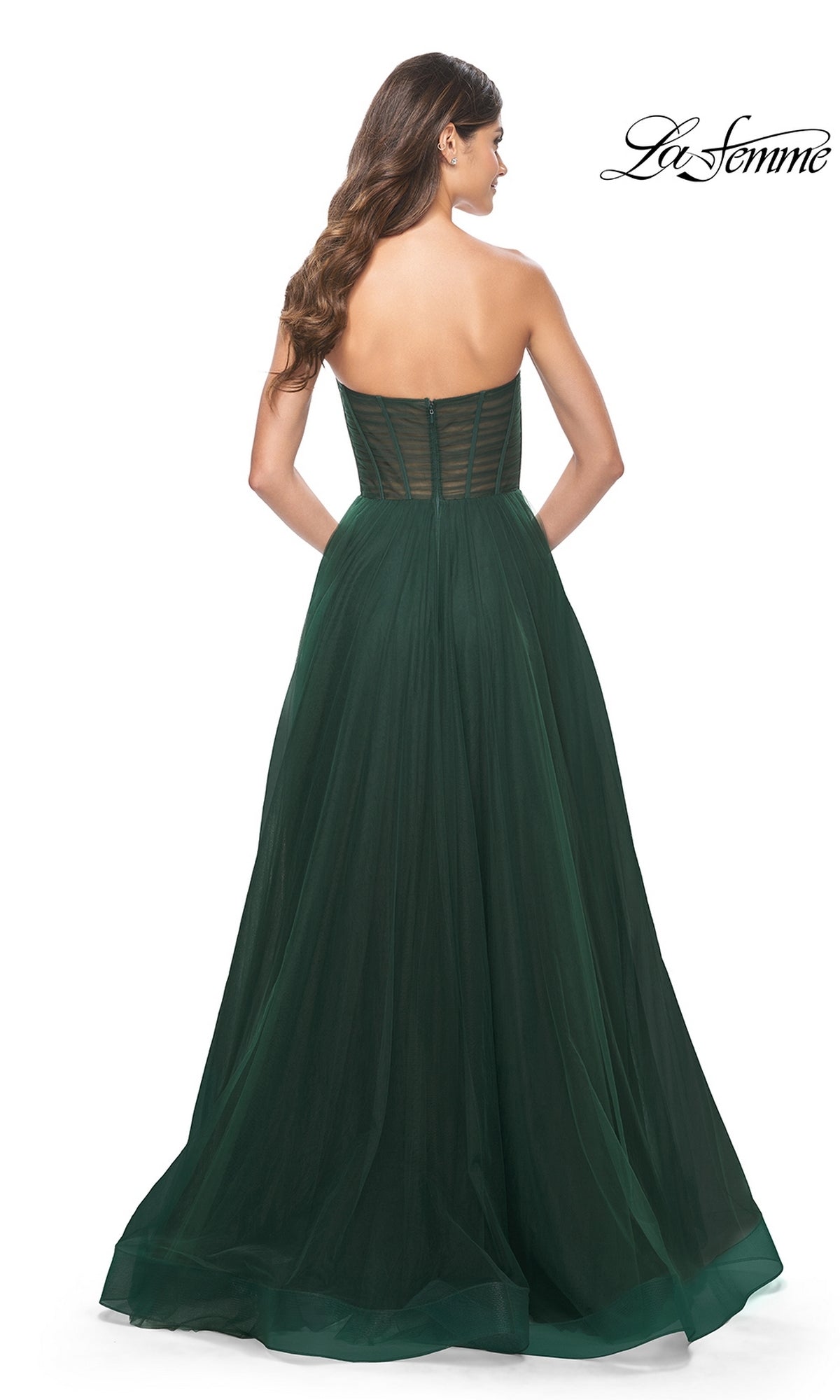 Woman wearing the La Femme Strapless Long A-Line Prom Dress 31971 in dark green tulle, featuring a fitted bodice and full skirt, shown from the back.